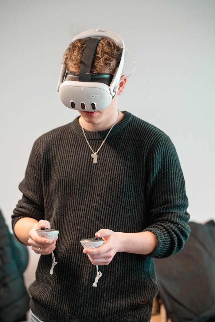 A young adult wearing a VR headset and controllers, fully immersed in a virtual reality experience indoors.