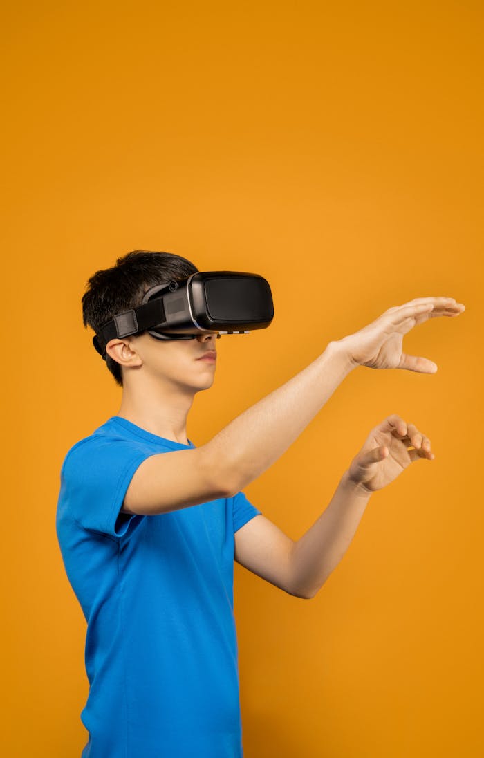 about-bg A young man wearing a VR headset experiencing a virtual reality world in front of a vibrant orange background.